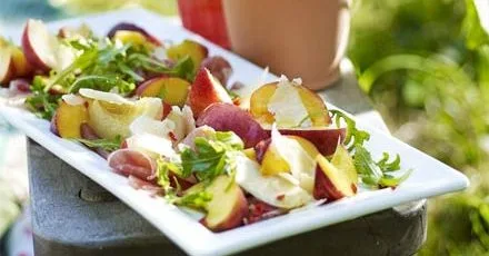 Antipasti on a plate: peaches with prosciutto