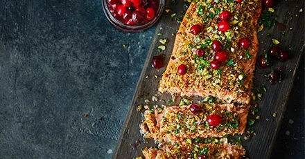 Запечене філе лосося з маринованою журавлиною, петрушкою та фісташками