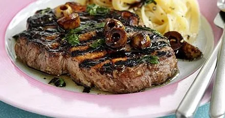 Juicy pork in balsamic sauce with olives