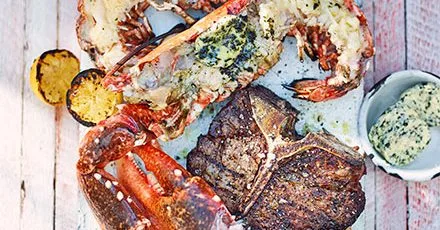 T‑bone Steak with Lobster and Aromatic Sea Butter on the Grill
