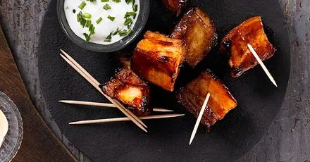 Bourbon-glazed pork belly chunks