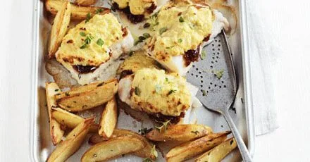 Cheese & onion rarebit-topped pollock with potato wedges