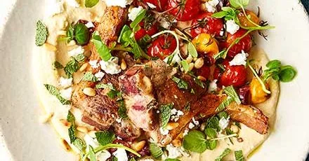 Lamb chops with hummus & roasted tomatoes