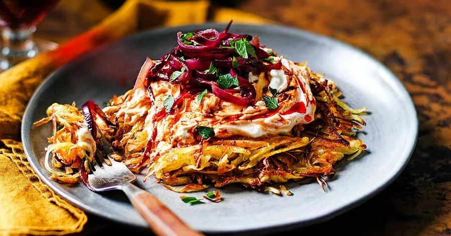 Parsnip rösti with harissa, feta & caramelised red onions