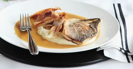 Roast fillet of sea bass with parsnip purée & caramelised garlic