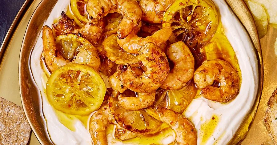 Sticky prawns with caramelised lemons & chilli on tahini yogurt
