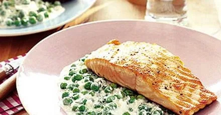 Stir fry of green peas with grilled salmon