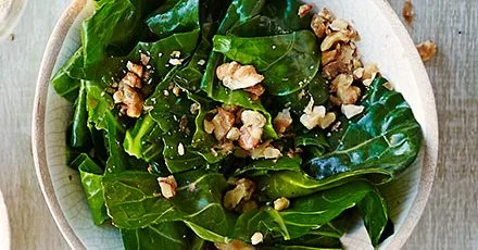 Wilted spring greens in nut oil
